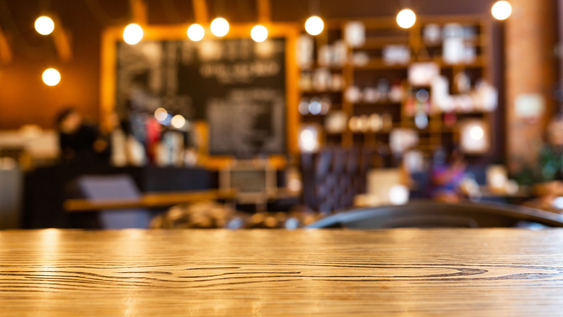 Warmly lit café interior with a wooden table